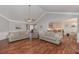 Open-concept living room with hardwood floors, neutral paint, and views of the kitchen at 108 Jasmine Way, Villa Rica, GA 30180