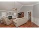 Cozy living room featuring a fireplace, hardwood floors, and neutral decor at 108 Jasmine Way, Villa Rica, GA 30180