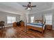 Spacious main bedroom with hardwood floors, a ceiling fan, and lots of natural light at 108 Jasmine Way, Villa Rica, GA 30180