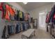 Spacious walk-in closet with custom shelving, clothing racks, full length mirror and bench seating at 108 Jasmine Way, Villa Rica, GA 30180