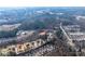 An aerial view shows the neighborhood, which is set among wooded areas at 1558 Autumn Wood Trl, Sugar Hill, GA 30518