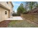A quaint patio and fenced backyard offer privacy with wooded views at 1558 Autumn Wood Trl, Sugar Hill, GA 30518