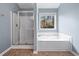Relaxing bathroom features a soaking tub and separate shower at 1558 Autumn Wood Trl, Sugar Hill, GA 30518