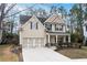 Charming two-story home with a well-maintained lawn and attached two car garage at 1558 Autumn Wood Trl, Sugar Hill, GA 30518