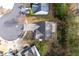 Aerial view of the home showcasing the backyard patio, landscaping and the driveway at 1558 Autumn Wood Trl, Sugar Hill, GA 30518