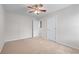 Bedroom featuring neutral carpet, ceiling fan and two doors at 1558 Autumn Wood Trl, Sugar Hill, GA 30518