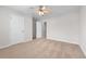 Bedroom features neutral carpet, a ceiling fan, and a window at 1558 Autumn Wood Trl, Sugar Hill, GA 30518