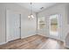 Dining area with wood-look floors, a door to the outside, and a decorative pendant light at 1558 Autumn Wood Trl, Sugar Hill, GA 30518