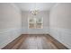 Elegant dining room with classic wainscoting and a stylish chandelier at 1558 Autumn Wood Trl, Sugar Hill, GA 30518