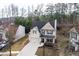 Aerial view of home featuring garage, dark roof, siding, professional landscaping and driveway at 1558 Autumn Wood Trl, Sugar Hill, GA 30518