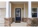 Charming front entrance with brick accents and a stylish black door at 1558 Autumn Wood Trl, Sugar Hill, GA 30518