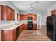Well-lit kitchen featuring wood cabinets, modern appliances, and granite countertops at 1558 Autumn Wood Trl, Sugar Hill, GA 30518