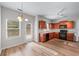 Eat-in kitchen features wood cabinets, black appliances, and a large window providing natural light at 1558 Autumn Wood Trl, Sugar Hill, GA 30518