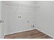 Laundry room with white walls, light-colored vinyl flooring and one wire shelf at 1558 Autumn Wood Trl, Sugar Hill, GA 30518