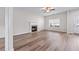 Cozy living room with fireplace, laminate flooring, and natural light at 1558 Autumn Wood Trl, Sugar Hill, GA 30518