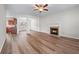 Open-concept living room boasts hardwood floors and a cozy fireplace at 1558 Autumn Wood Trl, Sugar Hill, GA 30518