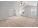 Spacious main bedroom with plush carpeting and lots of natural light at 1558 Autumn Wood Trl, Sugar Hill, GA 30518