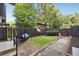 Serene fenced backyard featuring a swing, lush greenery, and a brick pathway at 290 Lakemoore Ne Dr # C, Atlanta, GA 30342