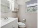 Bright bathroom with vanity, a round mirror, cabinet storage, and natural light from a window at 290 Lakemoore Ne Dr # C, Atlanta, GA 30342