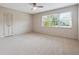 Spacious bedroom featuring a ceiling fan, neutral carpet, and abundant natural light from large windows at 290 Lakemoore Ne Dr # C, Atlanta, GA 30342