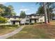 Inviting townhome featuring lush lawns, mature trees, and sidewalk at 290 Lakemoore Ne Dr # C, Atlanta, GA 30342
