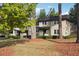 Beautiful townhome with a manicured lawn, large trees, and sidewalk at 290 Lakemoore Ne Dr # C, Atlanta, GA 30342