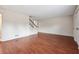 Bright, vacant living room featuring hardwood floors and staircase at 290 Lakemoore Ne Dr # C, Atlanta, GA 30342