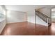 Spacious living room with hardwood floors, large windows, and staircase access at 290 Lakemoore Ne Dr # C, Atlanta, GA 30342