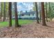 View of the home from the backyard, showcasing a well-maintained lawn, trees, and the property's exterior at 3345 Flowers Dr, Atlanta, GA 30337