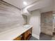 Basement featuring neutral colors, modern fixtures, and sink with countertop and wood cabinets at 3345 Flowers Dr, Atlanta, GA 30337