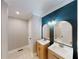 Well-lit bathroom featuring double sinks, framed mirrors, and tiled shower and bathtub at 3345 Flowers Dr, Atlanta, GA 30337