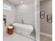 Luxurious bathroom featuring a modern soaking tub, elegant tile work, and stylish decor at 3345 Flowers Dr, Atlanta, GA 30337