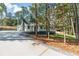 Exterior of the home with updated stone chimney, freshly painted trim, and a long concrete driveway at 3345 Flowers Dr, Atlanta, GA 30337