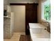 Modern kitchen features barn door, farmhouse sink, and elegant white countertops at 3345 Flowers Dr, Atlanta, GA 30337