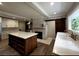 Large kitchen features a brick fireplace, barn door, spacious island, and stainless appliances at 3345 Flowers Dr, Atlanta, GA 30337