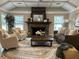 Inviting living room featuring a stone fireplace, comfortable seating, and a stylish area rug at 3345 Flowers Dr, Atlanta, GA 30337