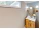 Stylish powder room featuring modern vanity, patterned wallpaper, and decorative lighting at 3345 Flowers Dr, Atlanta, GA 30337