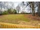 This spacious, grassy backyard is enclosed by a wood fence at 1506 Sycamore Nw Dr, Kennesaw, GA 30152