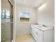 This bathroom features double sinks, granite counters, and a tiled shower at 1506 Sycamore Nw Dr, Kennesaw, GA 30152