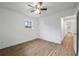 A well-lit bedroom with hardwood floors, showing a hallway to another room at 1506 Sycamore Nw Dr, Kennesaw, GA 30152