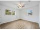 This bedroom features two windows, a ceiling fan, and wood-look floors at 1506 Sycamore Nw Dr, Kennesaw, GA 30152