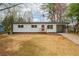 Charming one-story home with a red door, fresh white siding, and well-manicured yard at 1506 Sycamore Nw Dr, Kennesaw, GA 30152