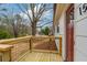 Inviting front porch with wooden deck and modern black metal railing at 1506 Sycamore Nw Dr, Kennesaw, GA 30152