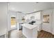 Bright white kitchen featuring modern appliances, quartz countertops, island, and hardwood floors at 1506 Sycamore Nw Dr, Kennesaw, GA 30152