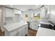 Close-up of bright white kitchen featuring modern appliances, quartz countertops, and hardwood floors at 1506 Sycamore Nw Dr, Kennesaw, GA 30152