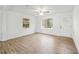 Cozy living room boasting new vinyl floors, fresh paint, and large windows at 1506 Sycamore Nw Dr, Kennesaw, GA 30152