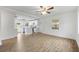 Bright living room open to the modern kitchen, featuring stylish flooring and ample natural light at 1506 Sycamore Nw Dr, Kennesaw, GA 30152