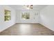 Sunlit living room featuring stylish flooring, a ceiling fan, and freshly painted white walls at 1506 Sycamore Nw Dr, Kennesaw, GA 30152