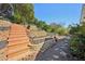 Backyard featuring wooden steps and stone retaining walls, and lush landscaping at 172 Shallow Ridge Ne Ln, Kennesaw, GA 30144