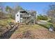 Backyard view of home featuring a spacious deck, patio area and mature trees at 172 Shallow Ridge Ne Ln, Kennesaw, GA 30144